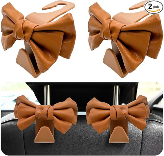 2 PCS Car Seat Headrest Hooks, Cute Bow Shaped Vehicle Backseat Storage Hooks, Leather Bow Shaped Sturdy Car Seat Back Hooks for Purses/Coats/Umbrellas, Car Accessories (Brown)
